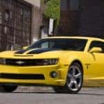 A yellow 2010 Chevy Camaro Transformers Edition is shown parked outside of a used Chevy dealership in Atlanta.