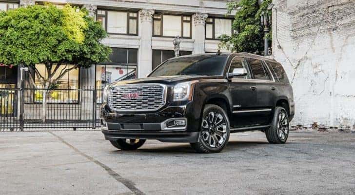 A black 2018 GMC Yukon Denali Ultimate is shown parked in a city lot after visiting a used GMC dealership in Atlanta.