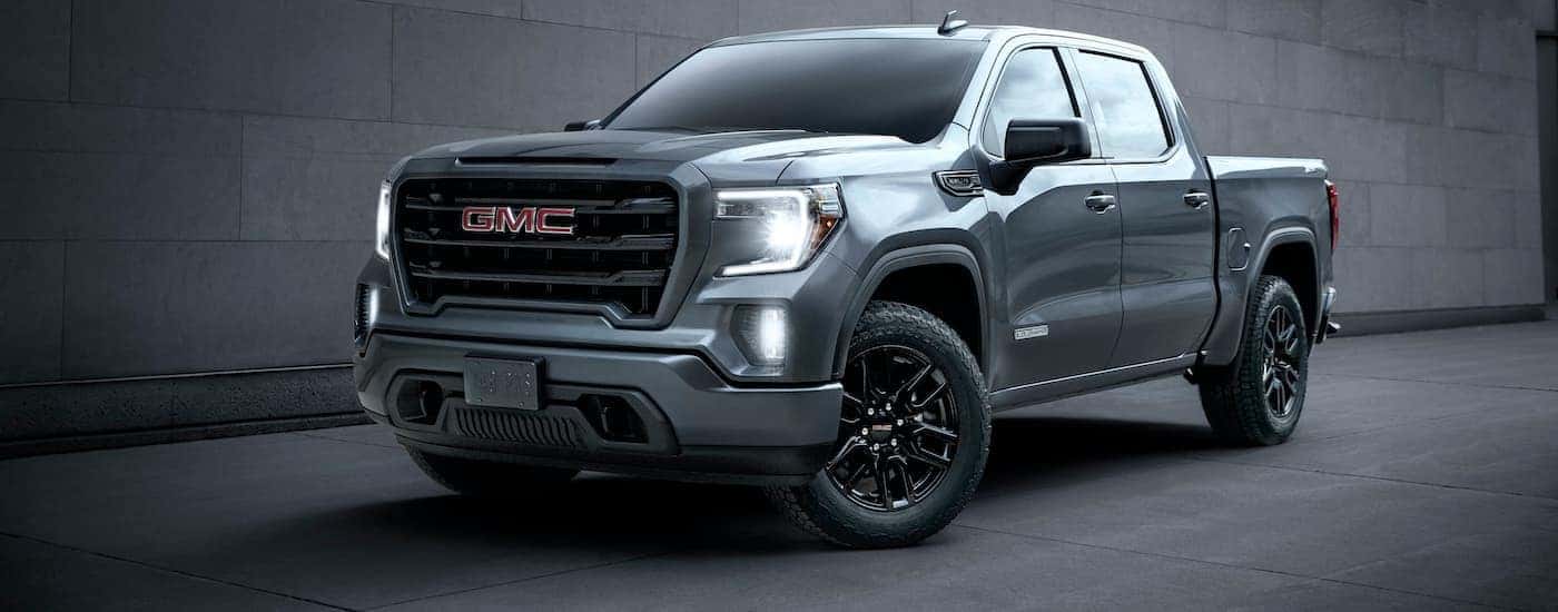 A grey 2020 GMC Sierra 1500 Elevation is shown parked in front of a cinderblock wall.