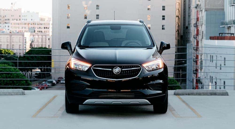 A black 2020 Buick Encore is shown from the front parked on the roof of a city building.