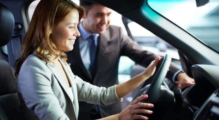 A person is shown sitting in the drivers seat of a car at a Norcross Buick dealer.