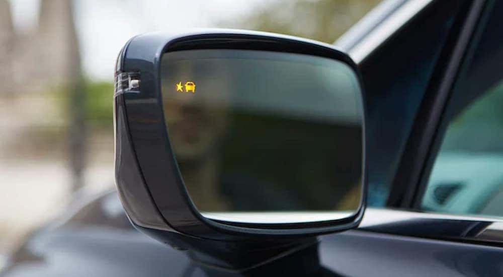 The lane safety mirror warning is shown on a Buick vehicle.