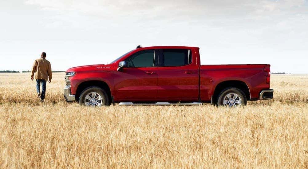 A red 2020 Chevy Silverado 1500 is shown parked in a field.