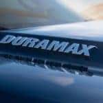 A close up of a blue 2021 Chevy Silverado 1500 shows the Duramax logo.