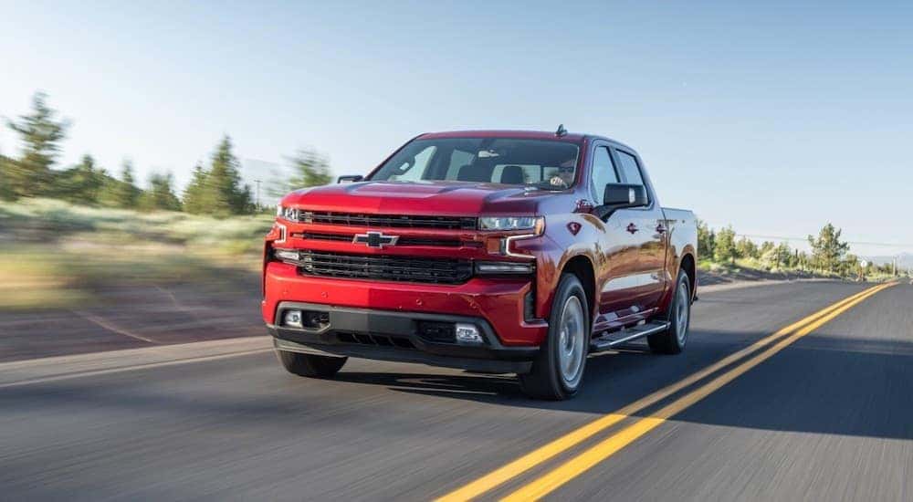 A red 2020 Chevy Silverado is shown from the front while it drives down the road after leaving an Atlanta truck dealer.
