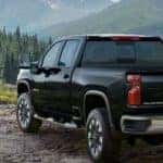 A black 2022 Chevy Silverado 2500HD Custom is shown from a rear angle after leaving a used Chevy dealership in Atlanta.