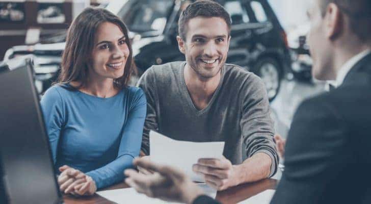 A couple is shown talking to a salesperson.