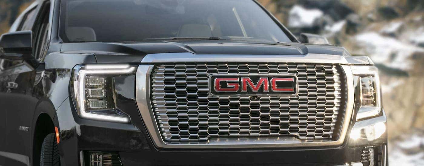 The grille of a black 2023 GMC Yukon Denali Ultimate is shown in close up.