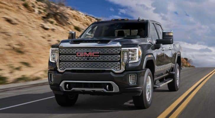 A black 2021 GMC Sierra 2500 HD Denali is shown from the front at an angle after leaving a dealer that has used GMC Sierra 2500 for sale.
