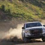 A white 2022 GMC Canyon AT4 is shown from the front after leaving a dealer that has used trucks for sale in Duluth.