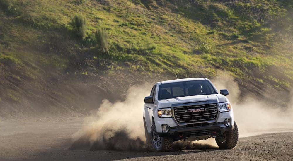 A white 2022 GMC Canyon AT4 is shown from the front after leaving a dealer that has used trucks for sale in Duluth.
