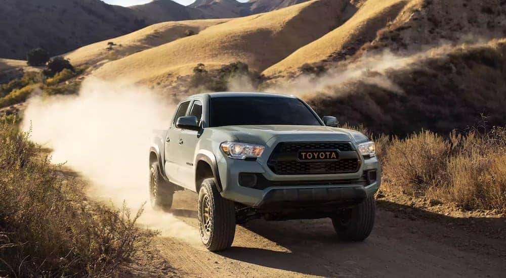 A grey 2022 Toyota Tacoma is shown from the front on a trail.