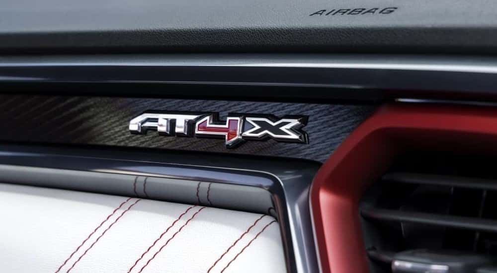 A close up shows AT4X badge on the dash of a 2023 GMC Canyon AT4X.