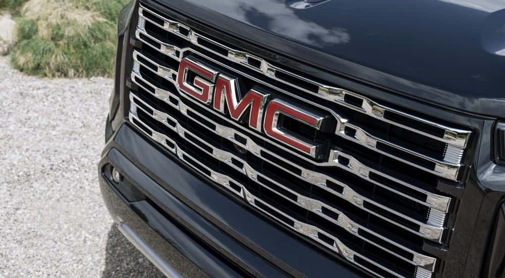 AS close up shows the grille on a black 2023 GMC Canyon Denali .