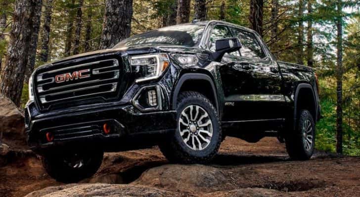 A black 2019 GMC Sierra AT4 is shown from the front while off-road after leaving a dealer that has Used lifted trucks for sale in Duluth.
