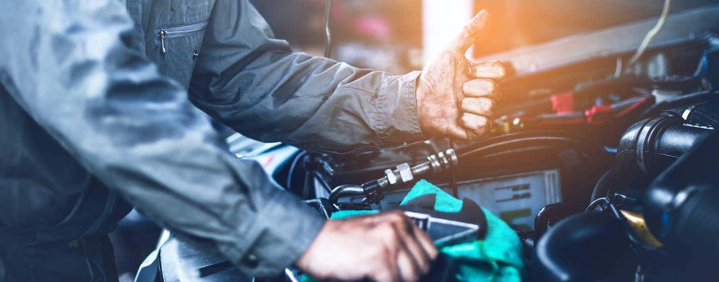 A mechanic is shown working on a truck.