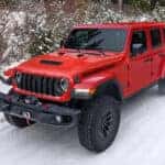 2026 Jeep Wrangler Rubicon driving on a snow-covered trail