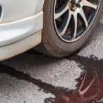 Car leaking fluid onto the pavement