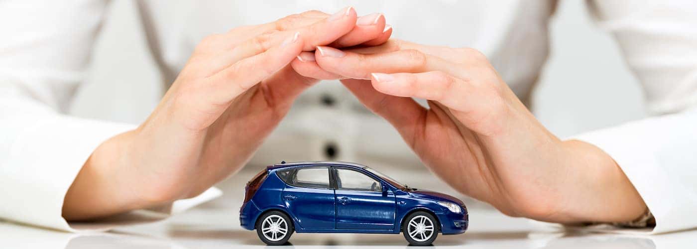 Hands Covering Car