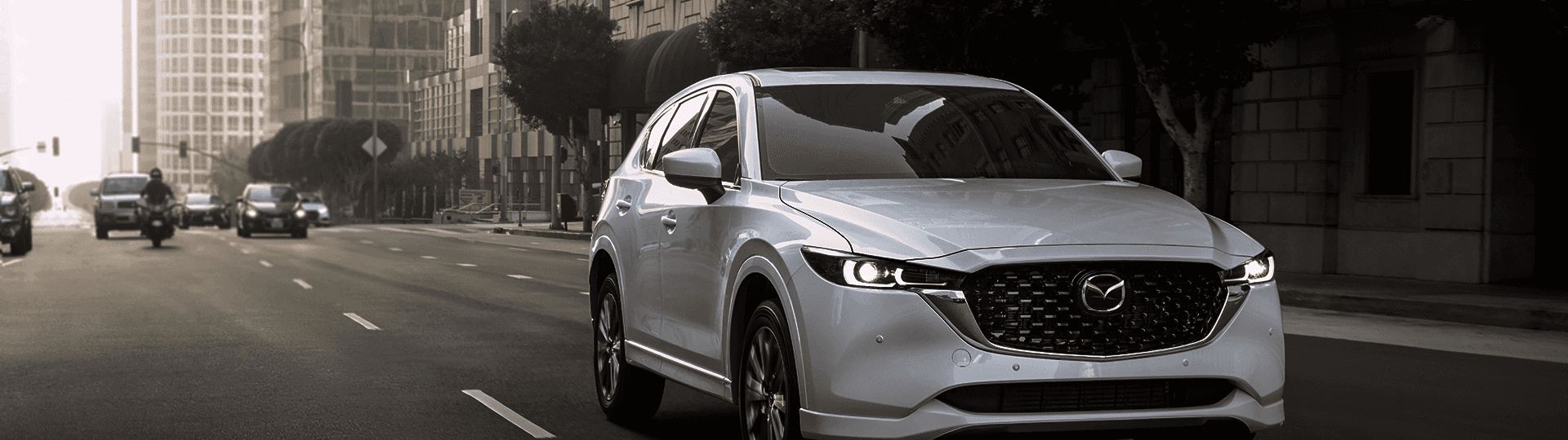Mazda driving through downtown