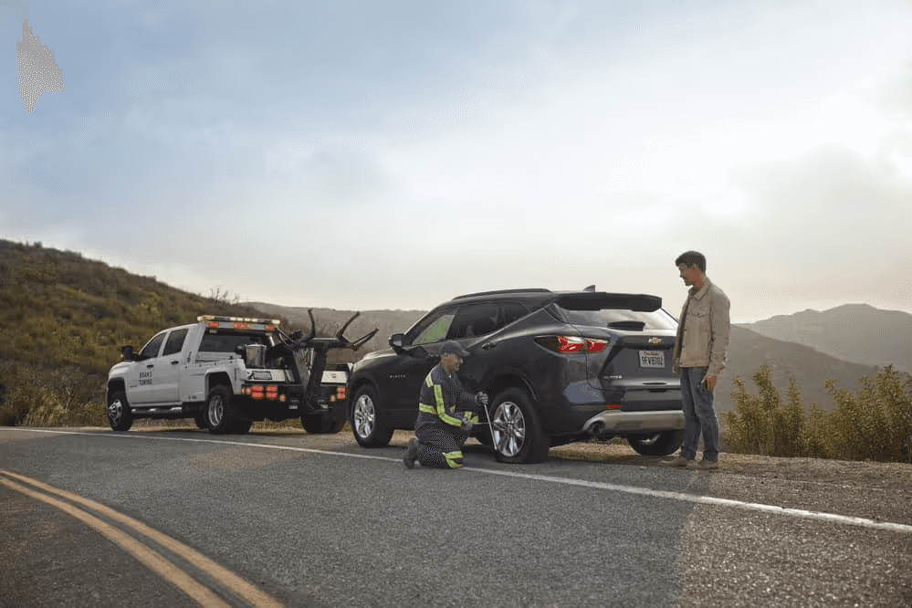Car broken on side of road being repaired