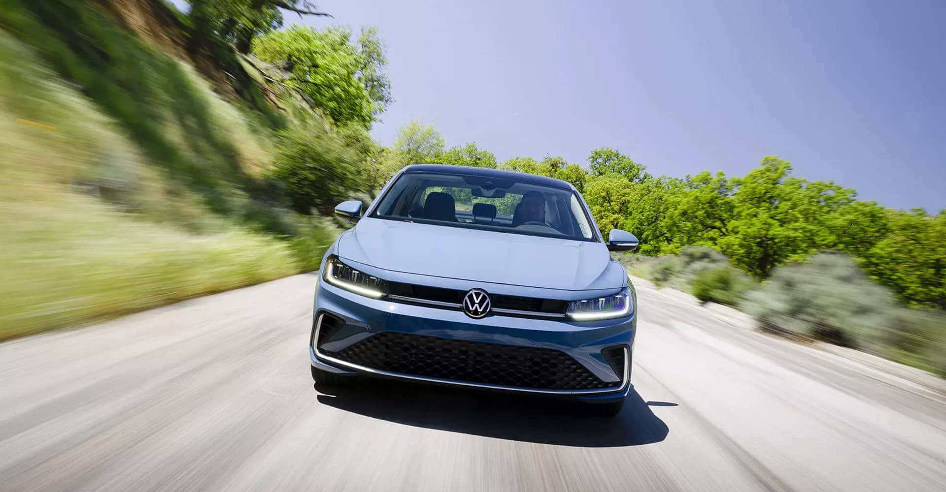 2025 Volkswagen Jetta Driving Down the Road
