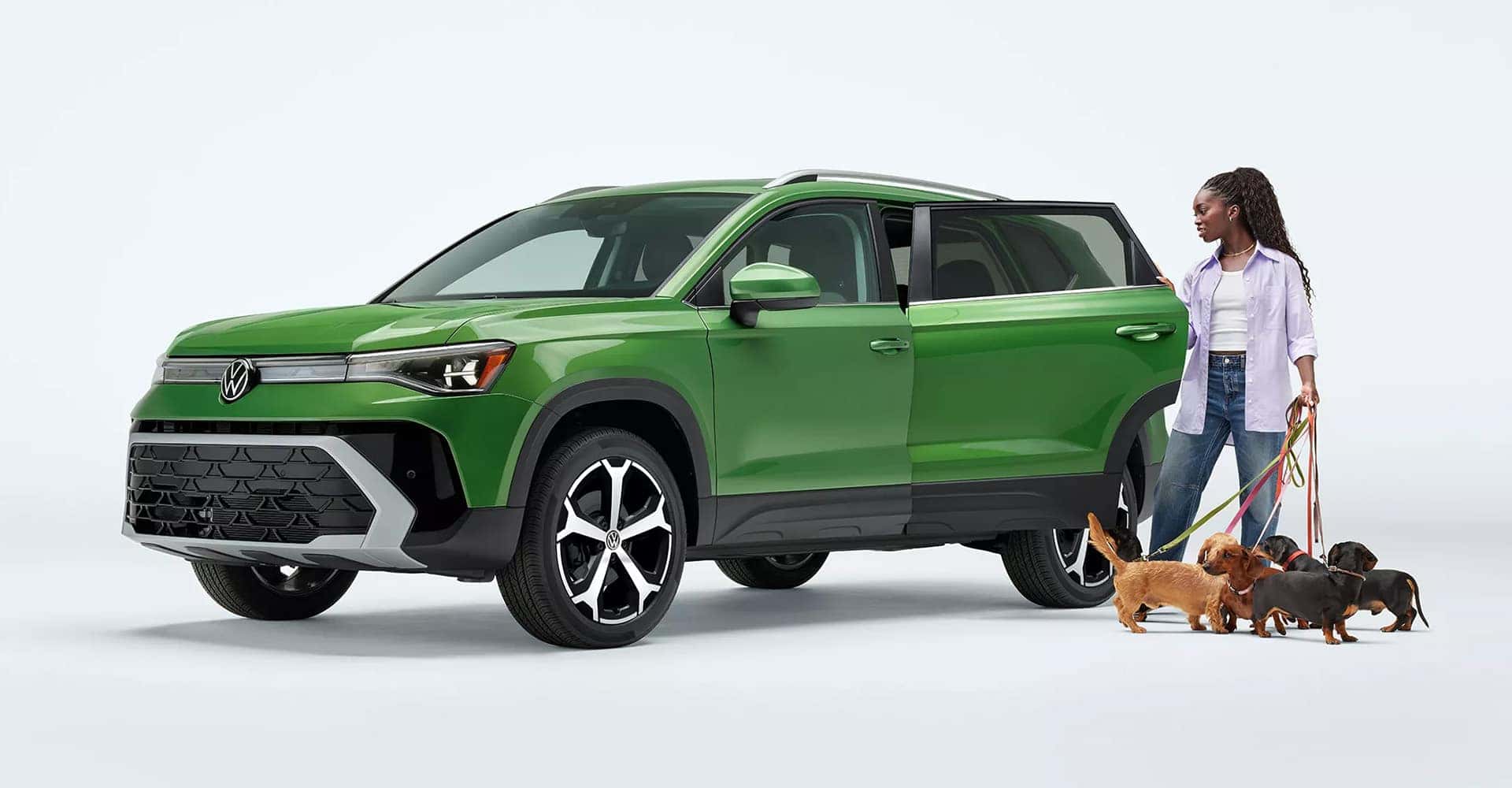 2025 VW Taos person with dogs opening door