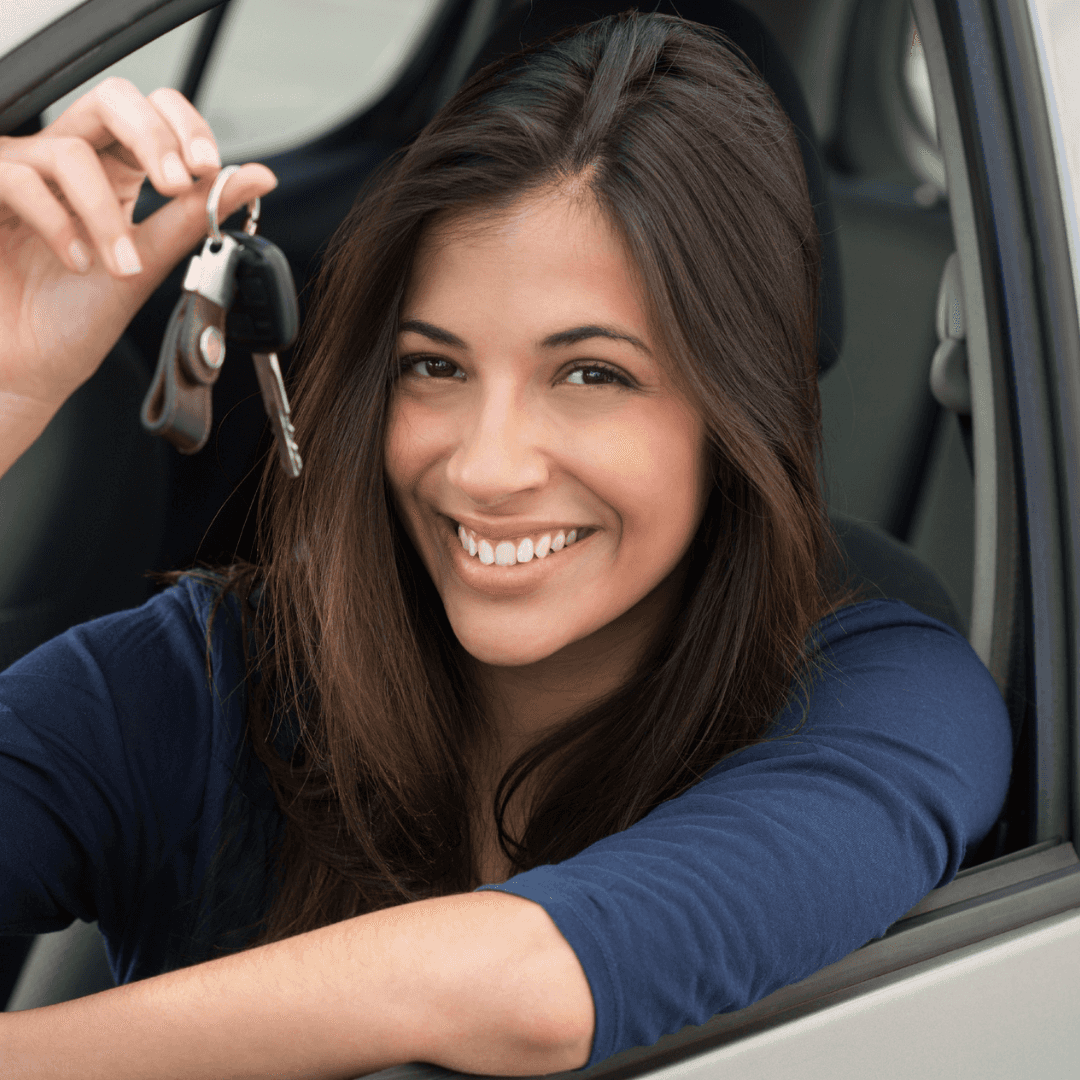 happy customer showing off new keys and car