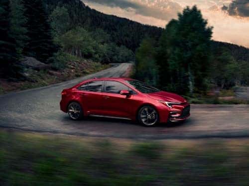 2024 Toyota Corolla Hybrid driving around a curve on a windy road