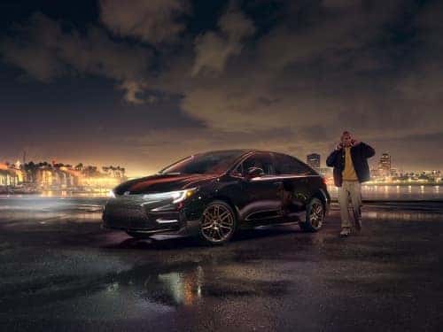 2024 Toyota Corolla Hybrid exterior view parked on a blacktop outside a city at night