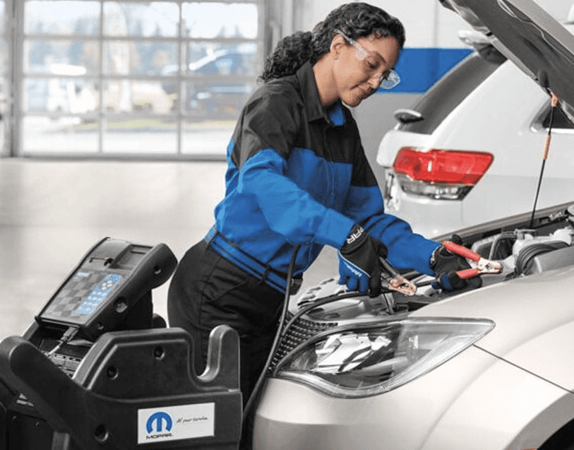 Technician inspecting a vehicle at Turlock Chrysler Dodge Jeep Ram