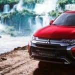 2020 Mitsubishi Outlander parked alongside waterfall