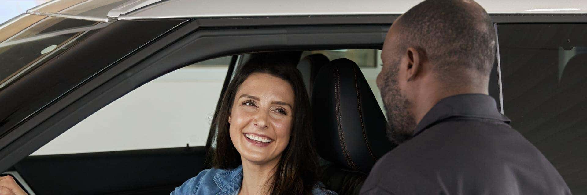 smiling customer sitting in driver seat