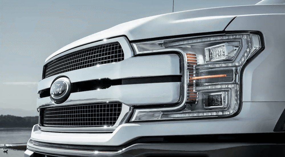 A close up of a white 2019 Ford F-150 grille is shown.