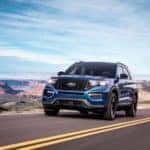 A blue 2020 Ford Explorer travels a open highway.