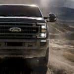 A black 2020 Ford Super Duty is driving on a dirt road near Carbondale, IL.
